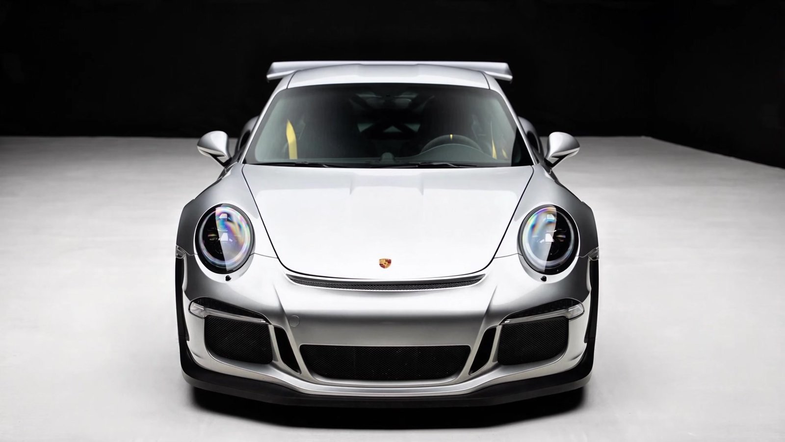 Silver Porsche viewed from the front — still from the featured film
